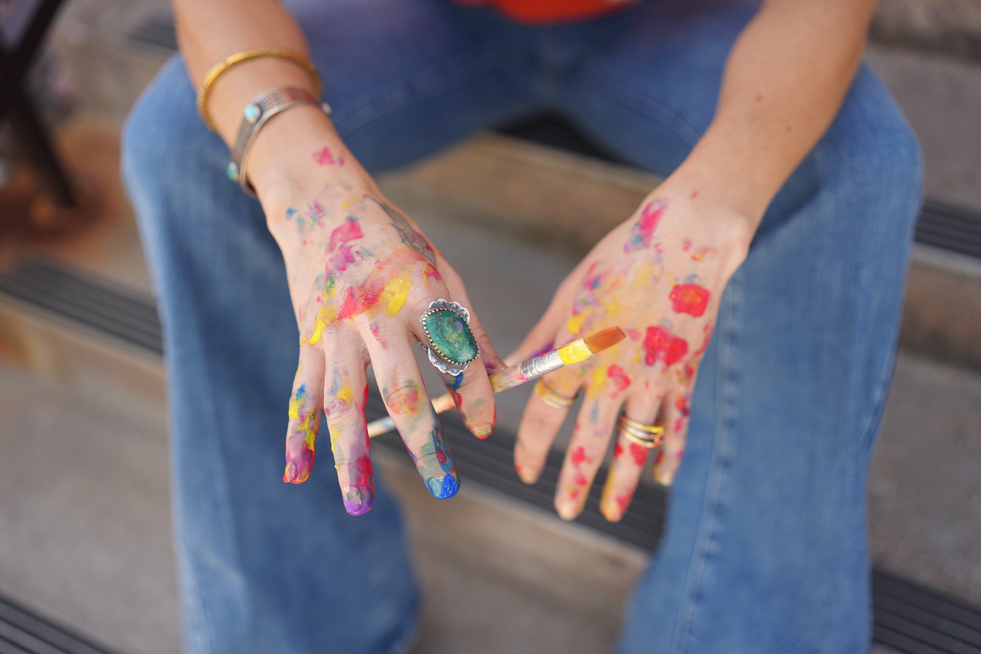 Hands with colorful paint during an art therapy workshop in Lakewood, CO